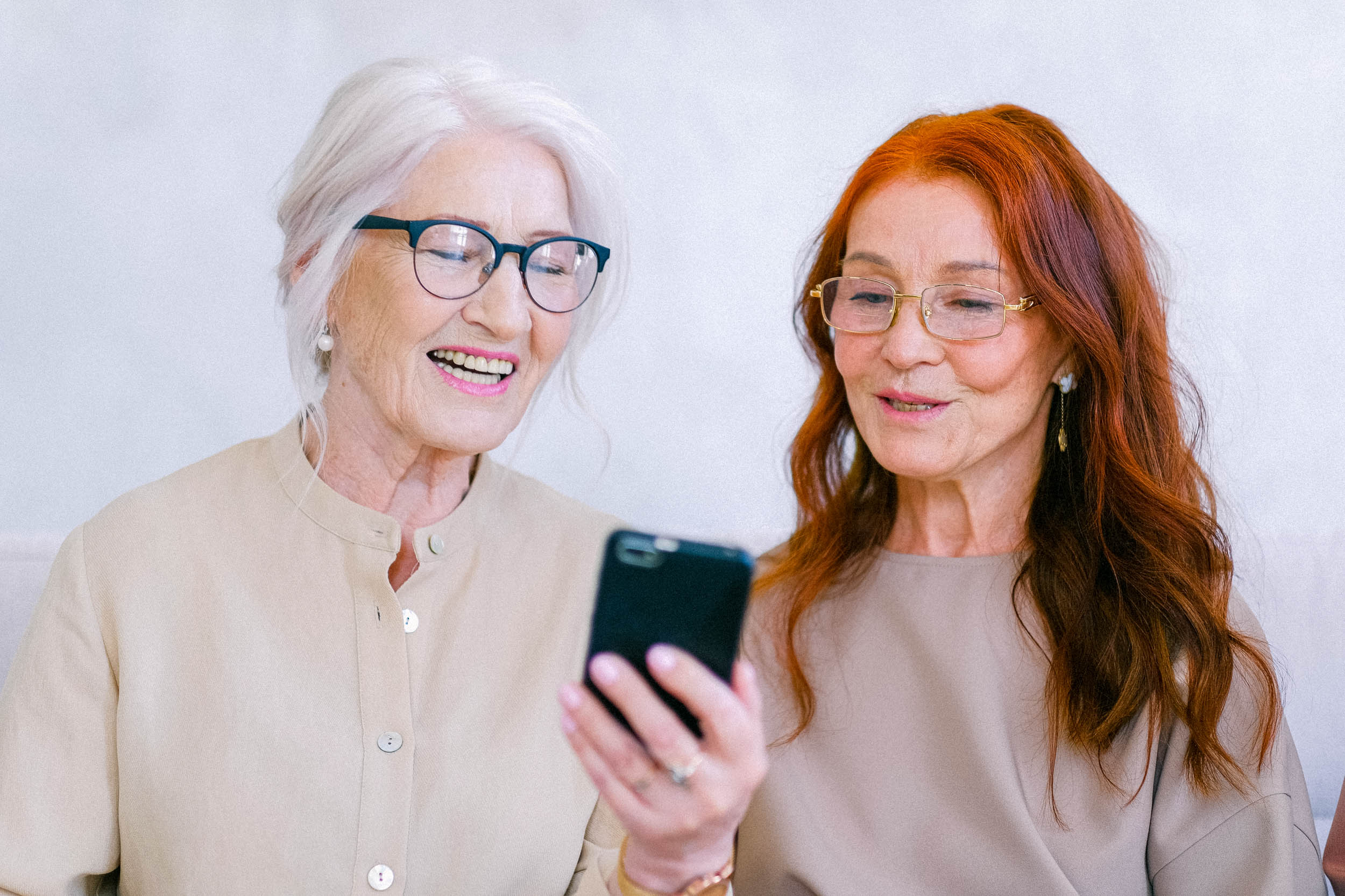 women-laughing-looking-at-phone